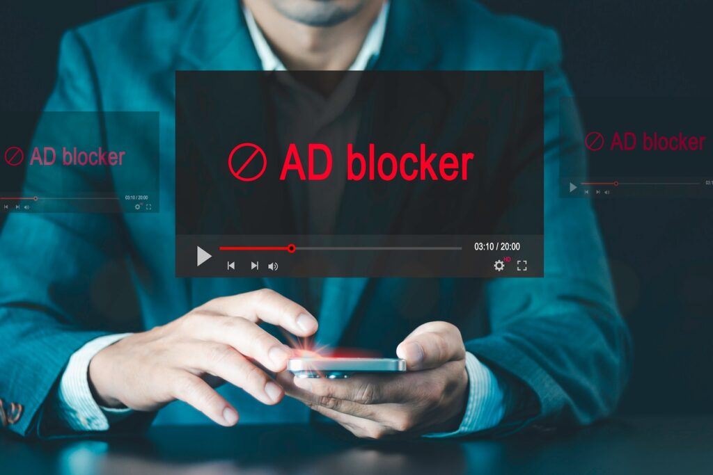 ad blocker, person using mobile phone blocking ads