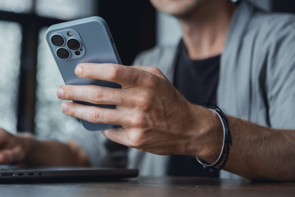 man holding iPhone block ads on iPhone