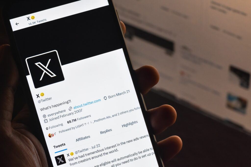 Selective focus of Twitter/X account on a mobile screen. Twitter privacy settings