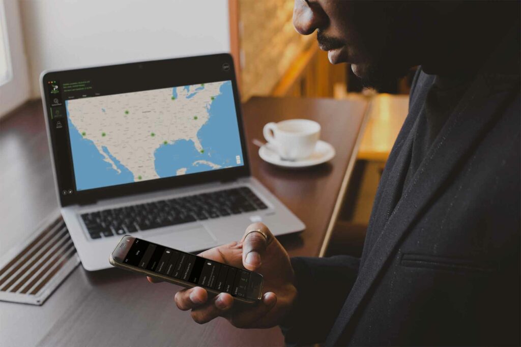 A person using IPVanish app on mobile and laptop devices