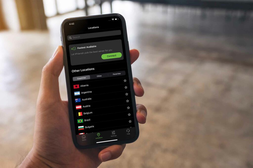 A person is seen using the IPVanish VPN iOS app in the Locations screen