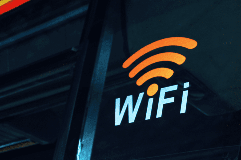 A Wi-Fi sign is seen in a window. Free Wi-Fi requires a hotspot vpn for safety
